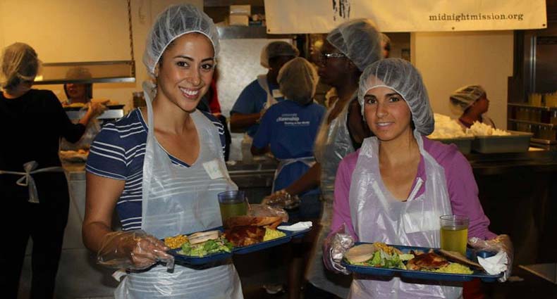 two women with food trays in a cafeteria