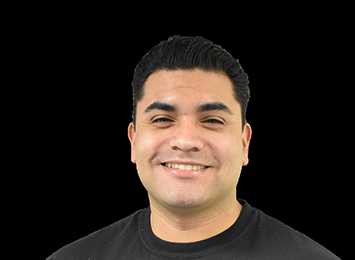 David Abrego Smiling In A Black Shirt Against A Dark Background With A Friendly Expression In A Professional Headshot