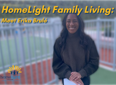 Homelight Family Living: Meet Erika Brule, Smiling Woman In Sweater Standing Outdoors By A Fenced Sports Field