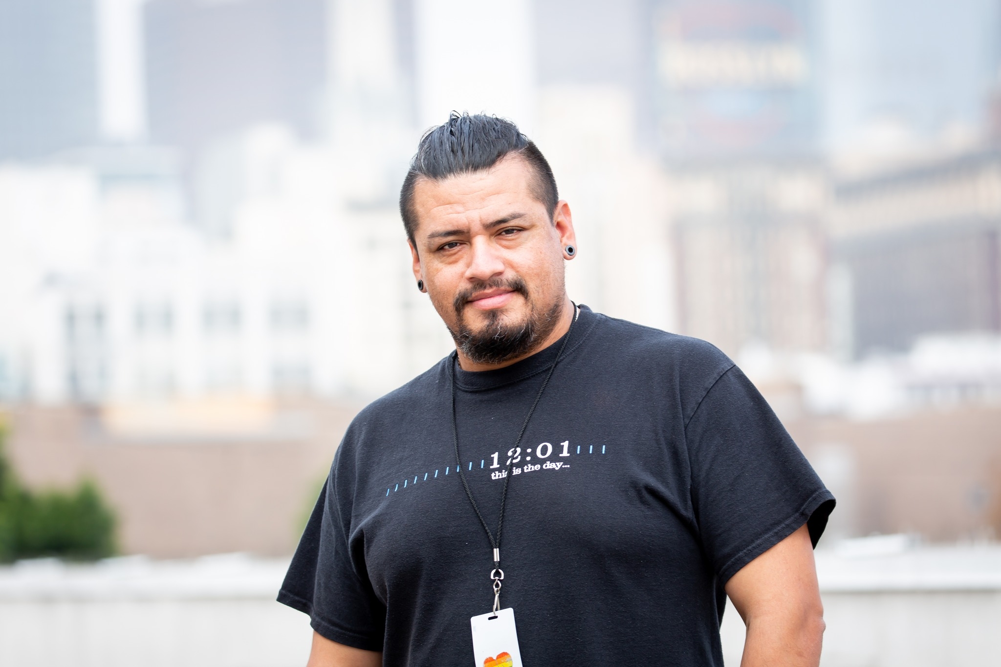 Andrew, A Proud Midnight Mission Alum, Stands On A Downtown Rooftop Overlooking Sunlit Los Angeles Skyline