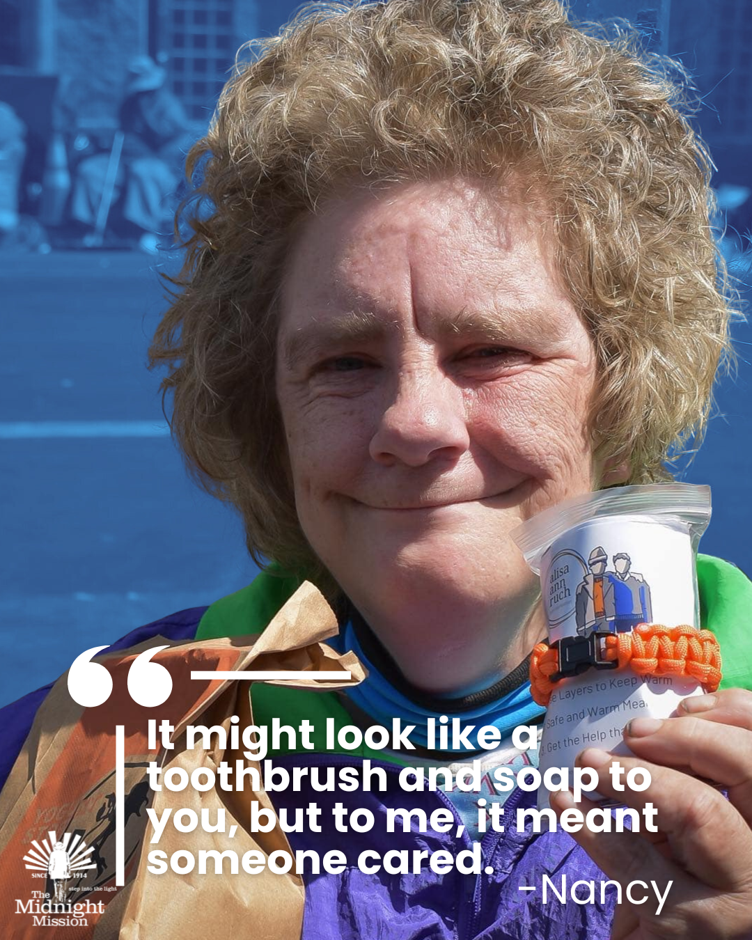 Woman holding donated care items with inspirational quote at The Midnight Mission in Los Angeles