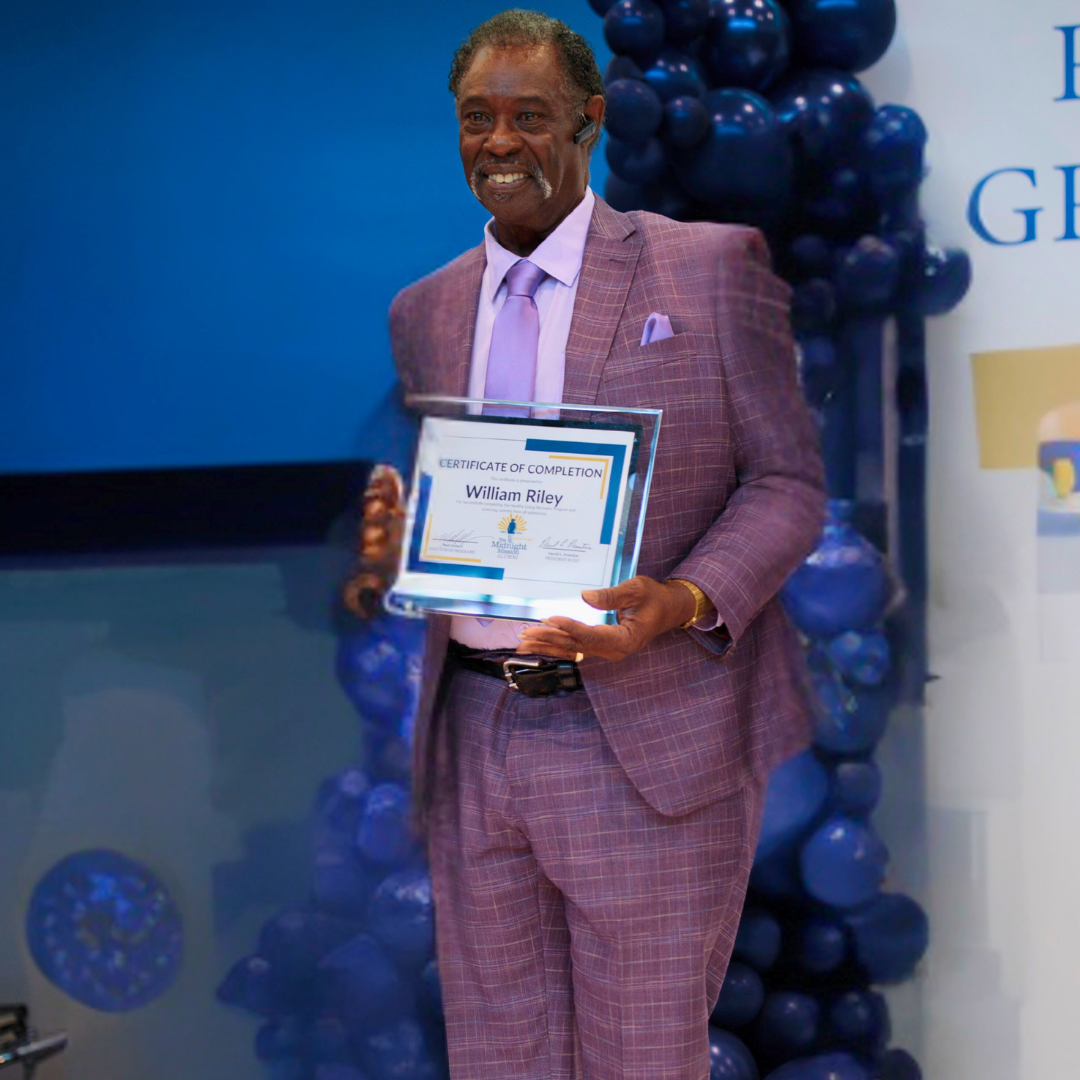 William Riley Smiles While Proudly Holding His Certificate Of Completion At Midnight Mission Graduation Event